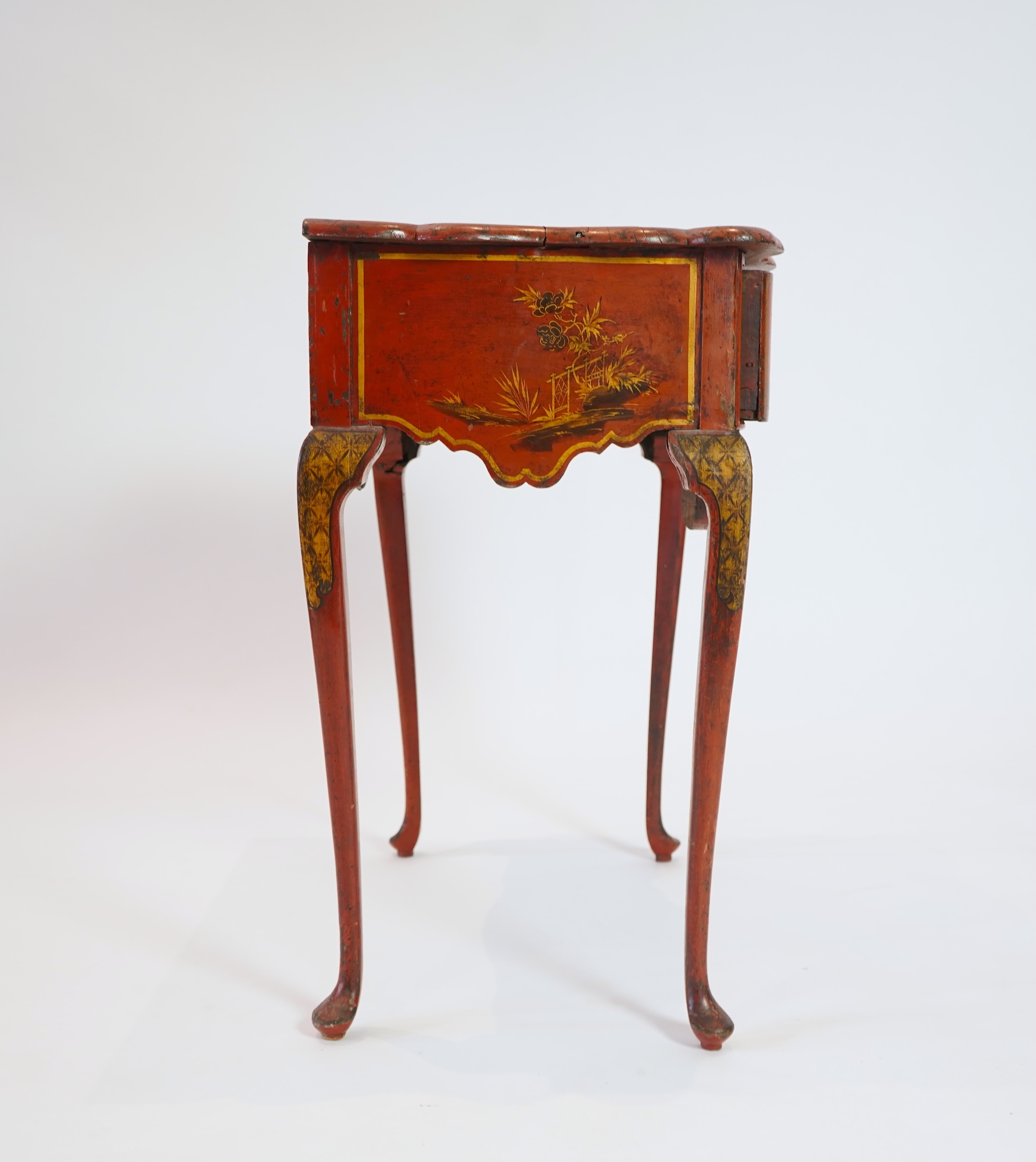 An early 18th century scarlet japanned lowboy